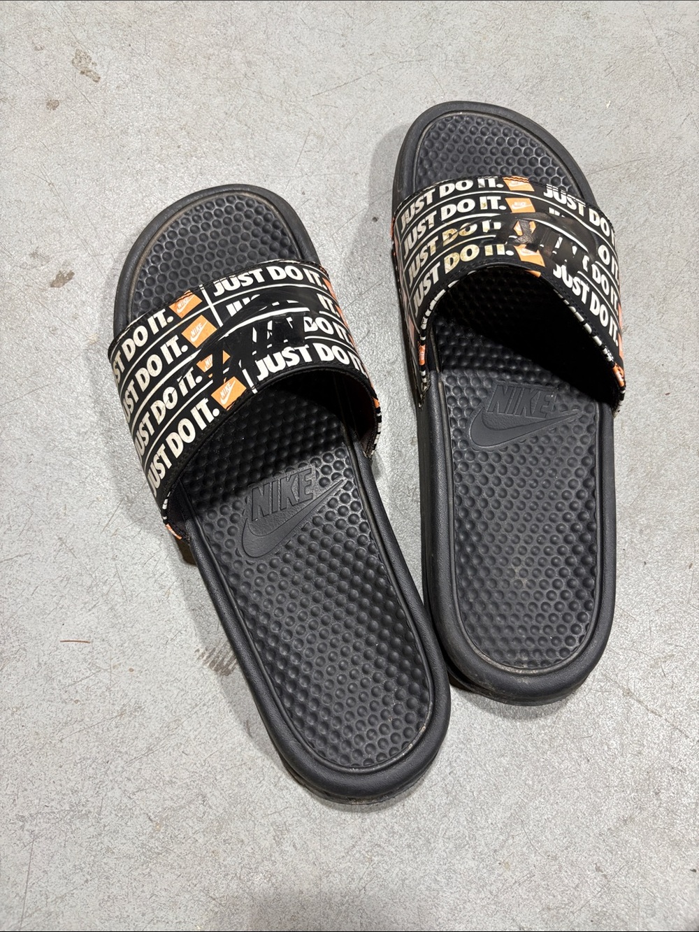 Nike Black Slides with 'Just Do It' Strap and Orange Accent